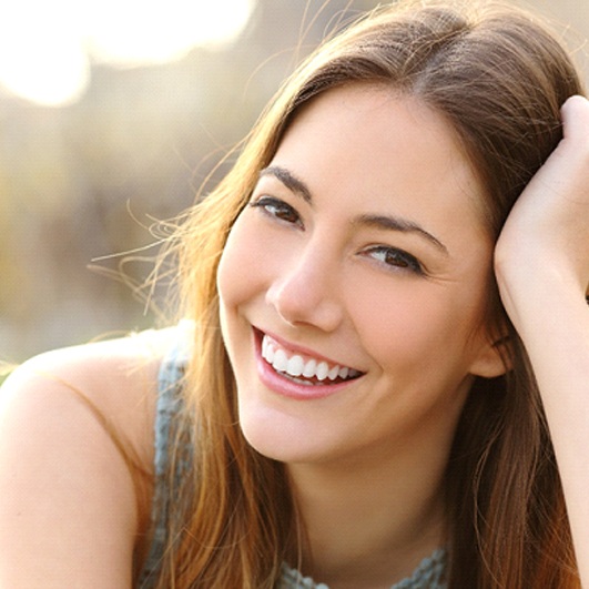 A young female smiling wide to show off her whiter teeth thanks to teeth whitening in Brick Township
