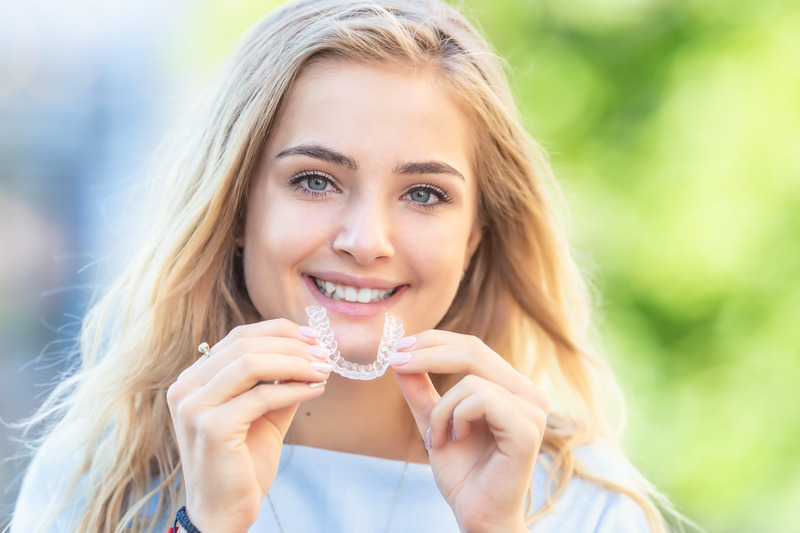 Patient smiling with their NU Smile Aligners